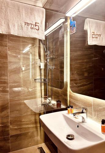 a bathroom with a sink and a mirror at FİFTY5 SUİTE HOTEL in Marmaris