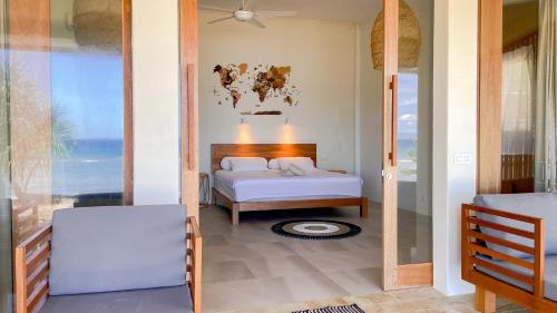 a bedroom with a bed and a view of the ocean at Sunset Beach Resort Weh in Sabong