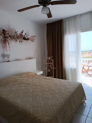 a bedroom with a bed and a ceiling fan at Rose's House in Grótta