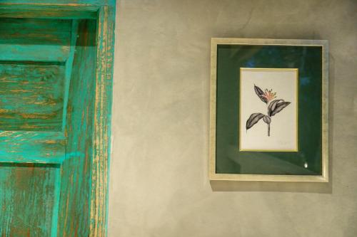 a picture of a flower on a wall at Tranquilisle in Kandy