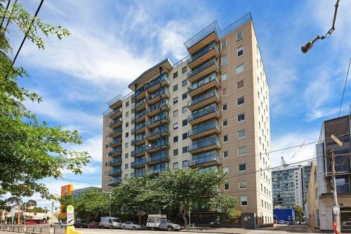 a tall apartment building on a city street at Spacious apartment minutes from the CBD in Melbourne