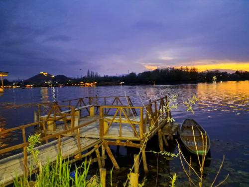 a dock in the middle of a lake at night at LakeSide Homestay Srinagar in Srinagar