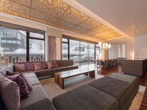 a living room with a couch and a table at Aya Niseko in Kutchan