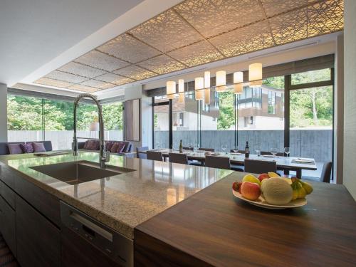 a kitchen with a sink and a plate of fruit on a counter at Aya Niseko in Kutchan