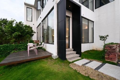 a house with a wooden deck with a table at XMAN Sunrise Peaks Resort--Free Pick-up in Zhangjiajie