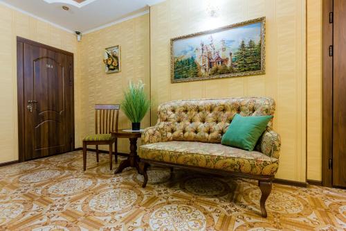 a living room with a couch and a table at Poznyakoff Aparthotel in Kyiv