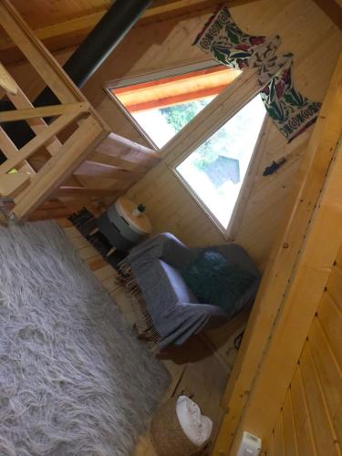 an overhead view of a living room with a window at Cabanutze Satic in Rucăr