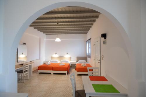 two beds in a room with an archway at Marina Blue Ornos in Ornos