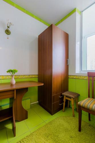 a room with a desk and a table and a bench at Poznyakoff Aparthotel in Kyiv