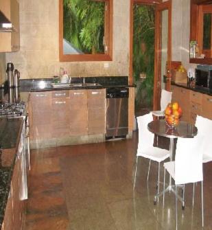 a large kitchen with a table and white chairs at Darbin ~ in Cannes