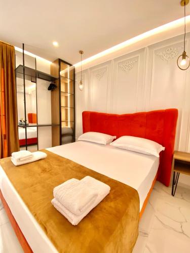 a bedroom with a large bed with two towels on it at Apartments Oda Hotel in Velipojë
