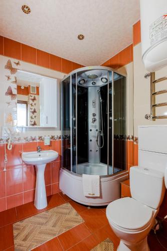 a bathroom with a shower and a toilet and a sink at Poznyakoff Aparthotel in Kyiv