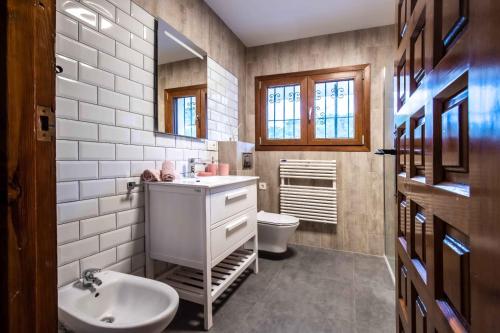 a bathroom with a sink and a toilet at Casa Soluna in Jávea
