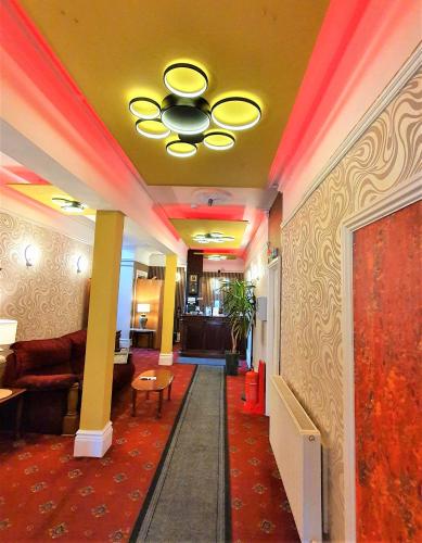 a lobby with a ceiling with red lights at Yardley Manor Hotel in Torquay