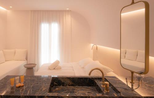 a hotel bathroom with a sink and a mirror at Petasos Chic Hotel in Mýkonos City