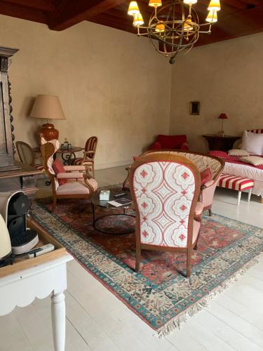 a living room with a bed and a table and chairs at Maison de la Pra in Valence