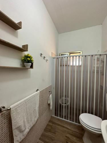a bathroom with a shower with a toilet and a sink at Giardino dei Baroni house in Marina di Mancaversa