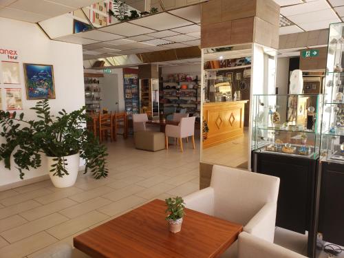 a restaurant with a table and chairs in a room at Napa Prince Hotel Apts in Ayia Napa