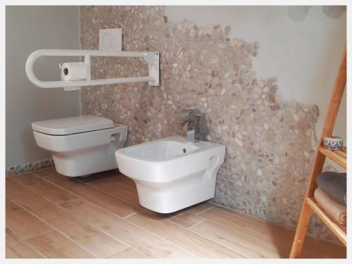 a bathroom with a toilet and a sink at La Casina in Trecasali