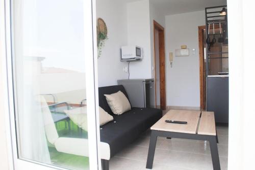 a living room with a couch and a table at Apartamentos Vicenta Playa Carihuela in Torremolinos
