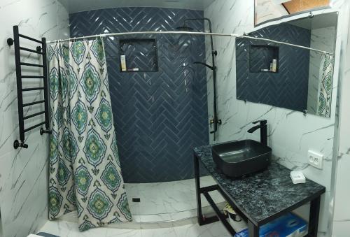 een badkamer met een douche en een wastafel bij Family house in Tasjkent