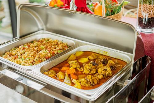 a metal container filled with different types of food at GREENECO DA LAT HOTEL - Khách sạn Green Eco Đà Lạt in Da Lat