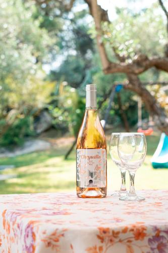 a bottle of wine sitting next to a wine glass at Spathies in Kalogria