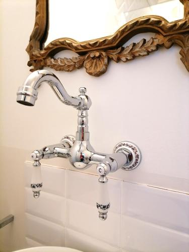 a bathroom with a sink and a mirror at CASA BELGERI - Bed & Breakfast in Dongio