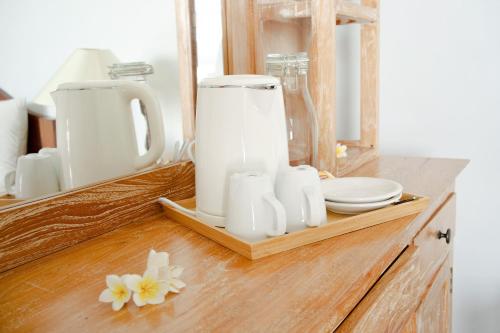 a counter with white appliances on a wooden shelf at Alam Bali Beach Resort in Amed