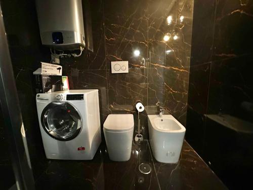 a bathroom with a washing machine and a sink at Trastevere Loft in Rome