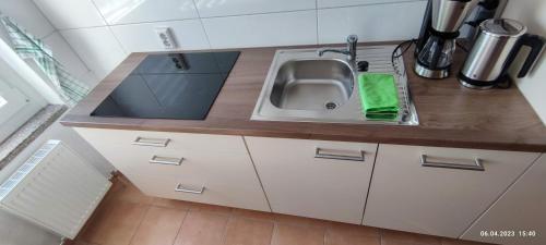 a kitchen with a sink and a counter top at Ferienwohnung Groitzsch in Groitzsch