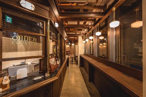 a restaurant with a bar with a ordering counter at Book Tea Bed SHIBUYA in Tokyo