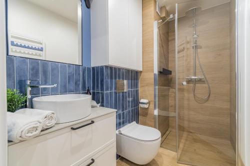 a bathroom with a shower and a toilet and a sink at APARTAMENTY MIERZEJA - STEGNA PARK STUDIO, 500 m od plaży, bezpłatny meleks in Stegna