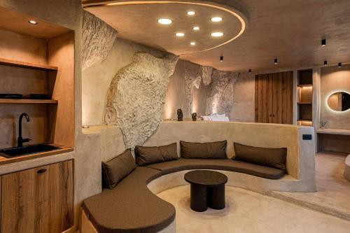 a living room with a couch and a table at Senses Luxury Houses in Fira