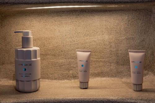 three bottles of moisturizing moisturizers sitting next to a moisturizing moisturizing moistur at Senses Luxury Houses in Fira