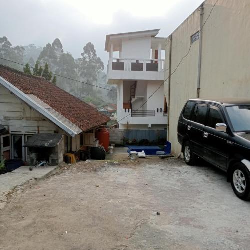 a black van parked in front of a house at Homestay putih Ciwidey in Ciwidey
