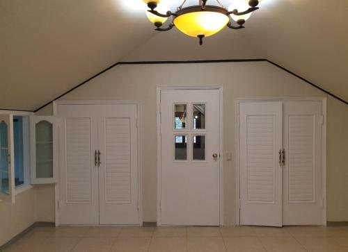 a room with two white doors and a chandelier at Gabriel Villa in Jeongseon