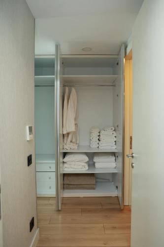 a walk in closet with white towels on a shelf at Deluxe 2BR Apartment Balcony 420 in Istanbul