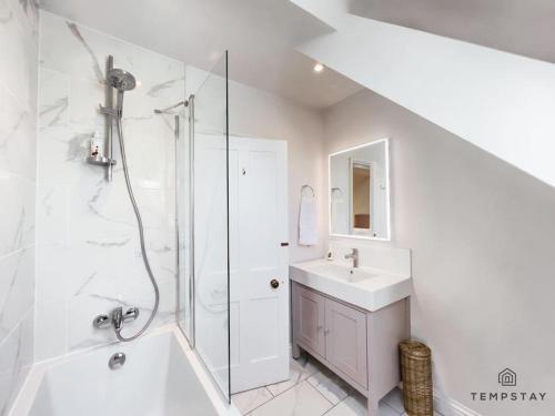 a white bathroom with a sink and a shower at The Long Walk: 3Bed & Garden in Windsor