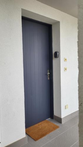 a blue door in a room with a rug at Appartement port de Vannes in Vannes