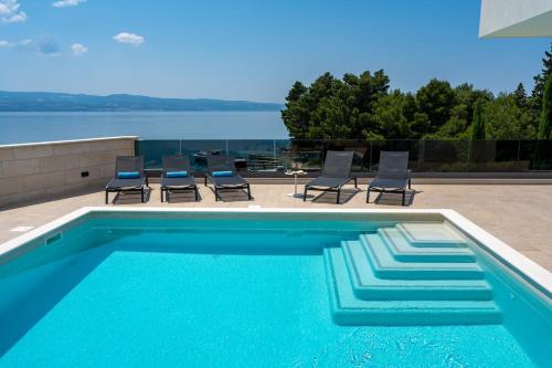 Luxury, seafront Villa Petra with heated pool only 50m from beach