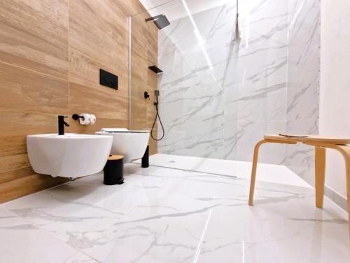 a bathroom with a white sink and a toilet at B&B ONE in Catania