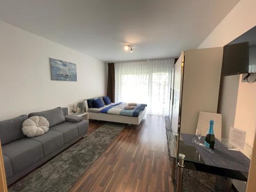 a living room with a couch and a bed at Relax and Spa - DeLux Apartman in Velence