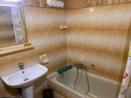 a bathroom with a sink and a bath tub next to a sink at Le p'tit coin montagne 3 in Bonneval-sur-Arc
