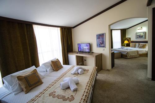 a hotel room with two beds and a mirror at RK MAGİC DREAM HOTEL in Kemer