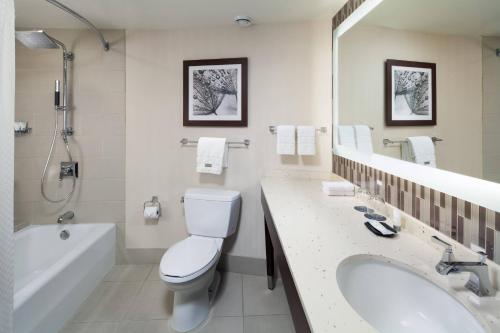 a bathroom with a toilet and a tub and a sink at The Westin Seattle in Seattle