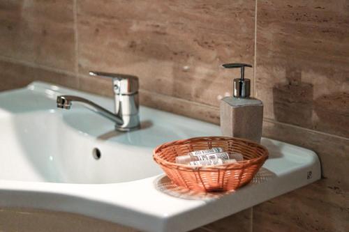 a bathroom sink with a basket on top of it at Aqua Vista Fratelli - Vedere Top la Mare si Lac - Summerland in Mamaia