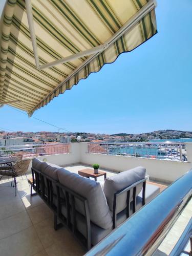 a balcony with chairs and a view of the city at Apartment Čiovo Radić in Trogir