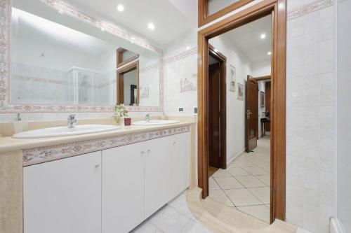 a bathroom with two sinks and a mirror at Pigneto Cozy Flat in Rome