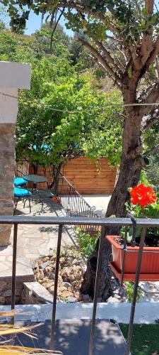 a table with flowers on it next to a tree at Villa Sarichel in Nikithianós